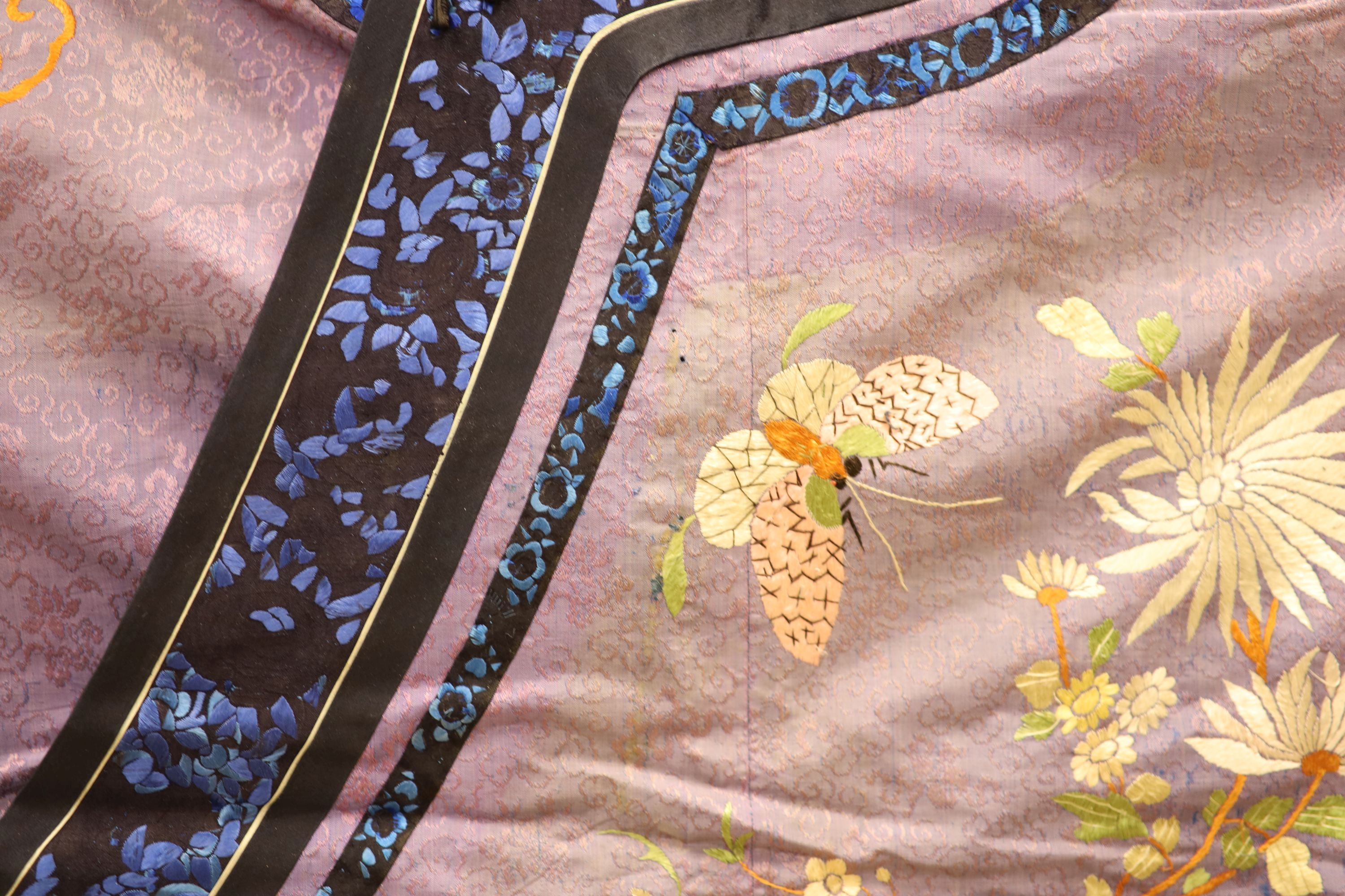 A Chinese lilac silk embroidered robe, early 20th century with multi-coloured embroidery and wide embroidered sleeve bands,